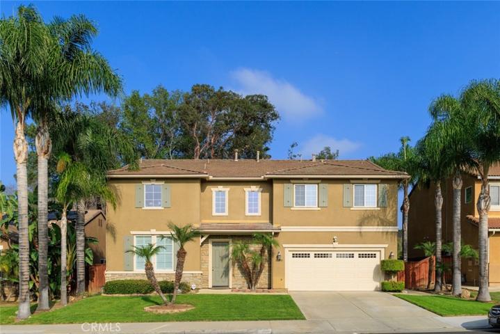 Queen Palms flank this prestigious Victoria Grove stunner!