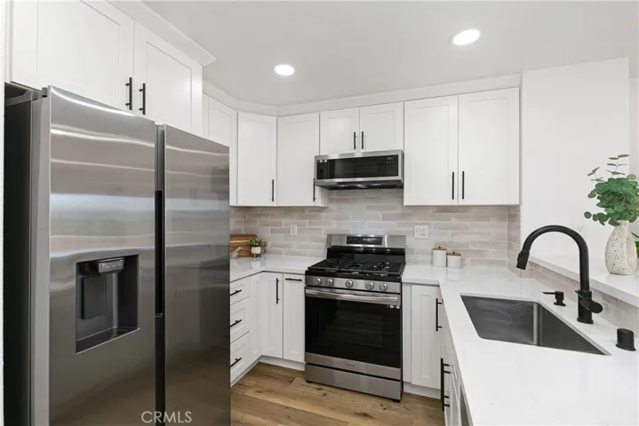 Kitchen view of basin sink & newer appliances