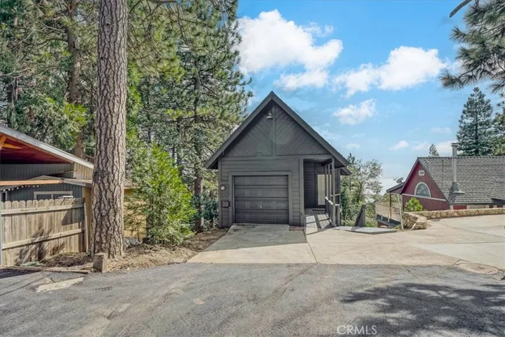 New asphalt leading to concrete driveway