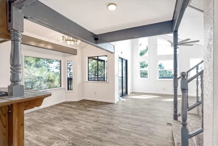 Looking towards Dining Room area and Living Room with high ceilings