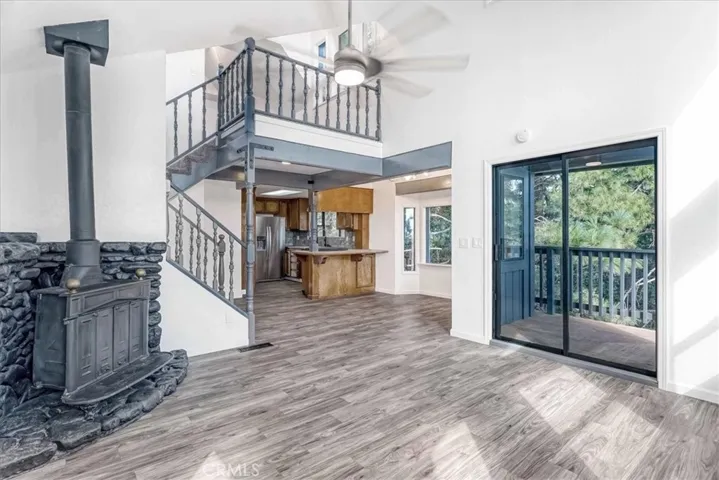 Living Room with wood burning stove and slider to one of the decks