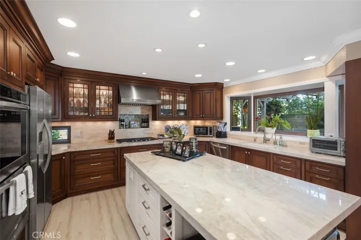 Great room across back of house with gorgeous remodeled and expanded kitchen with upgrades galore.