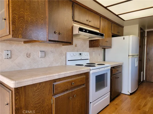 Cabinets constructed of actual wood and matching tile backsplash is a welcomed sight!