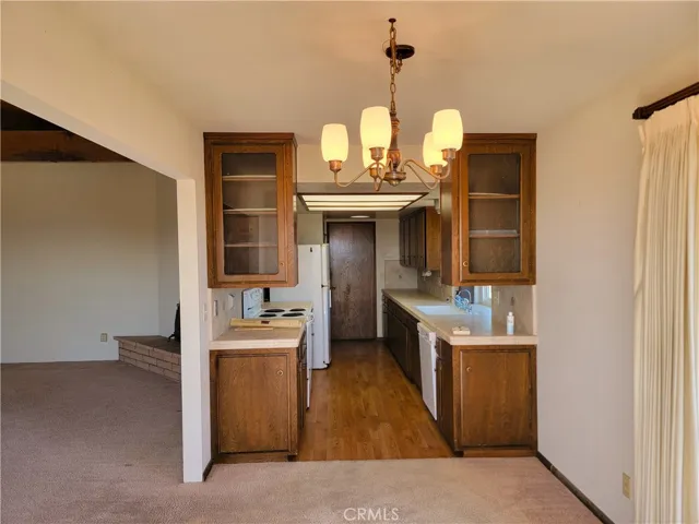 Typical kitchen design of mid 70's; today, that wall simply would not be there, and an island would be in its place.  Pretty simple really.