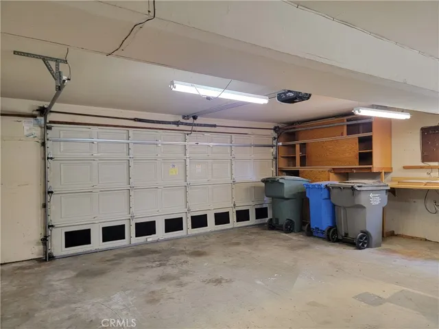 Additional Storage Space is found in built-in Garage cabinets alongside two workbenches!
