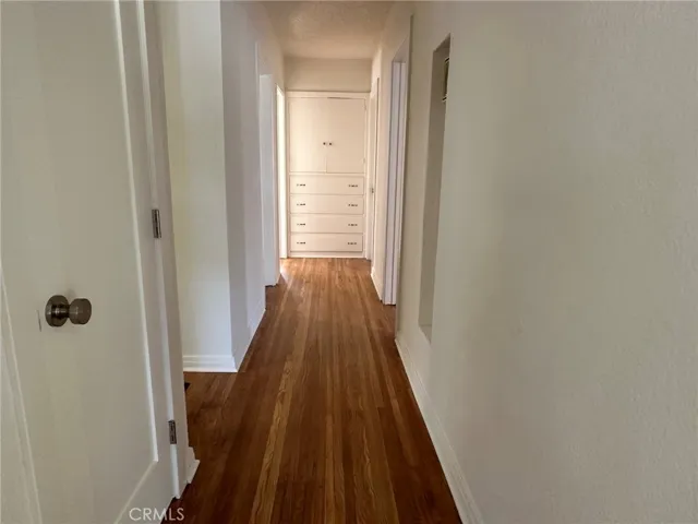 hallway leading to 3 bedrooms