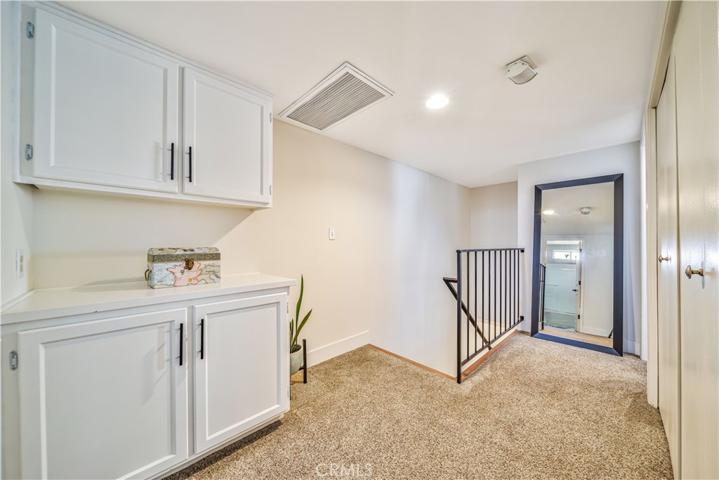 Upstairs landing w/ linen storage and laundry closet