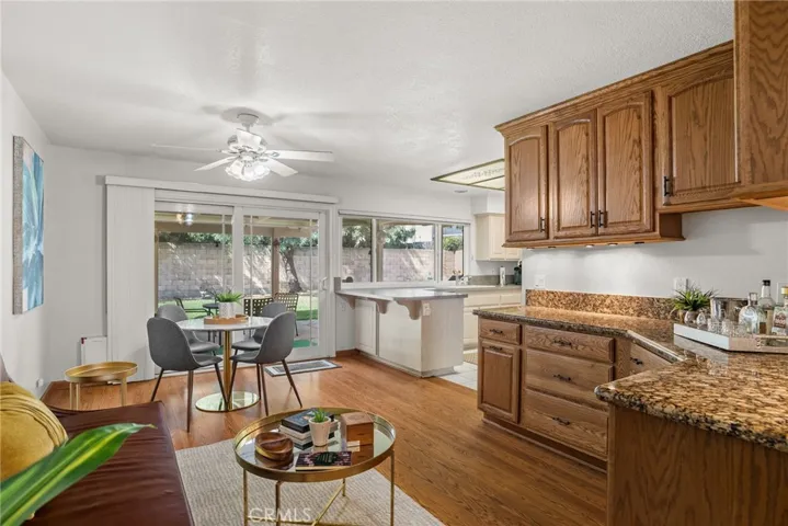 Family room has oak cabinets with lots of sliding drawers, granite countertop and under cabinet lights