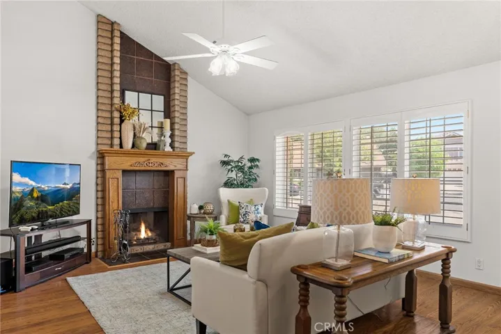 Elegant living room has fireplace with oak mantle and custom mirror
