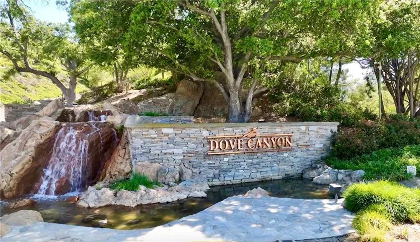 At the bottom of the drive up, beautiful Dove Canyon signage and waterfall.
