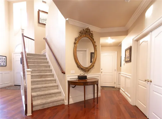 Double doors lead you to office or bedroom, straight is the garage, to the left is the laundry room and to the right is a full bath.