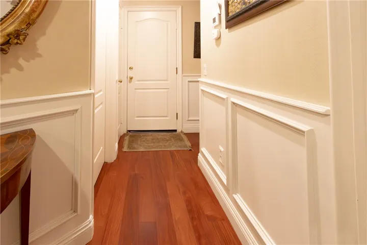 The halls, living room, dining room, and entryway boast exquisite high-quality wainscoting, adding a touch of elegance to the overall warmth of the home.