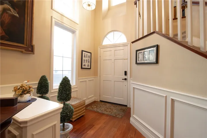 Step into this captivating home with its grand 18-ft soaring ceilings, bathed in an abundance of natural light streaming through the windows. The carefully chosen warm tones exude a sense of warmth and invitation, making this residence truly enchanting.