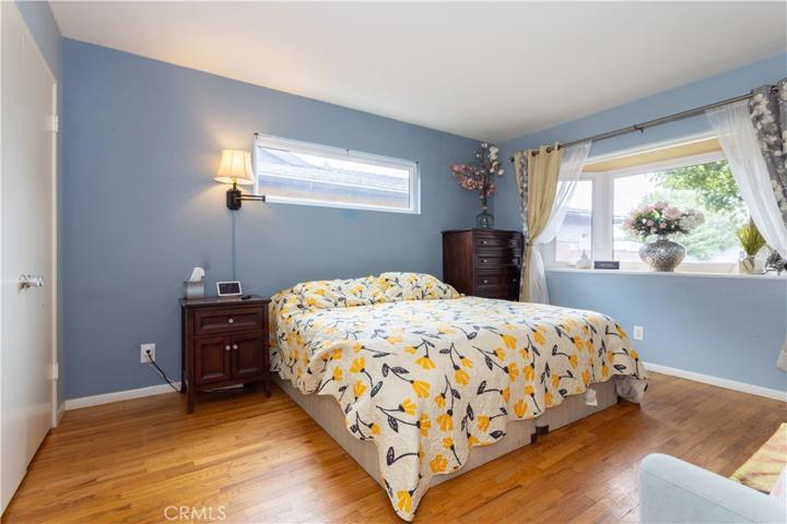 Primary bedroom with bay double paned windows.