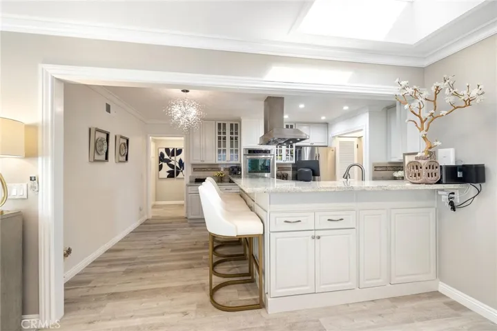 Kitchen is bright with skylight and recessed lights