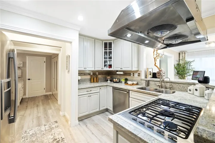 Stainless steel appliances, new cabinets and granite countertop in this remodeled kitchen.
