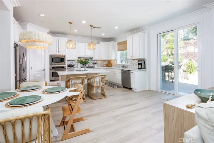 A welcoming heart of the house with upgraded features; walk-in pantry; new floring and lighting.