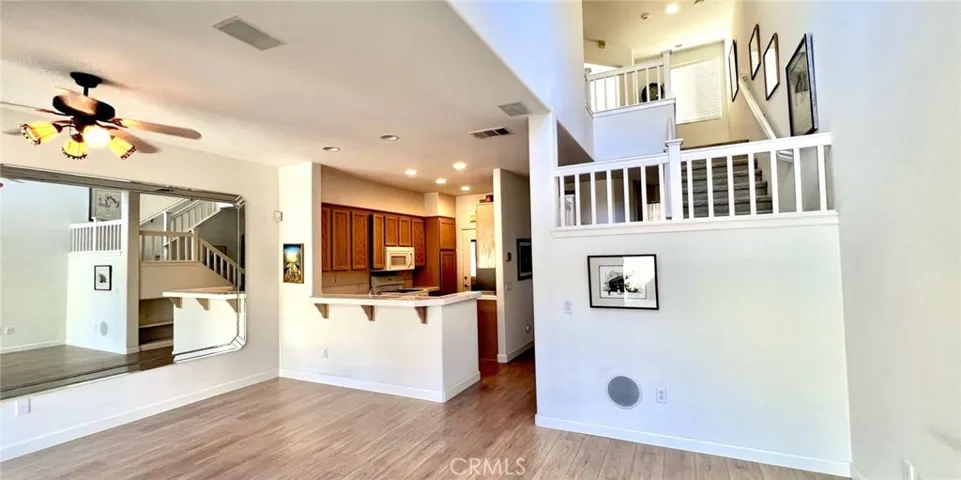 Living room is open to kitchen, new floors and custom mirror