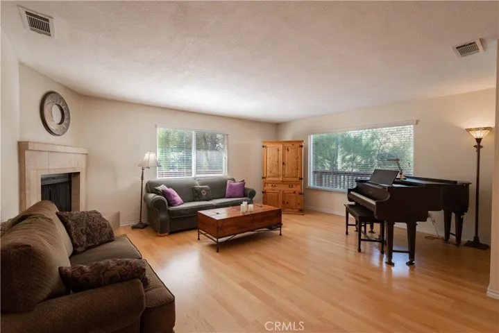 Large, open living room with picture windows and updated fireplace.