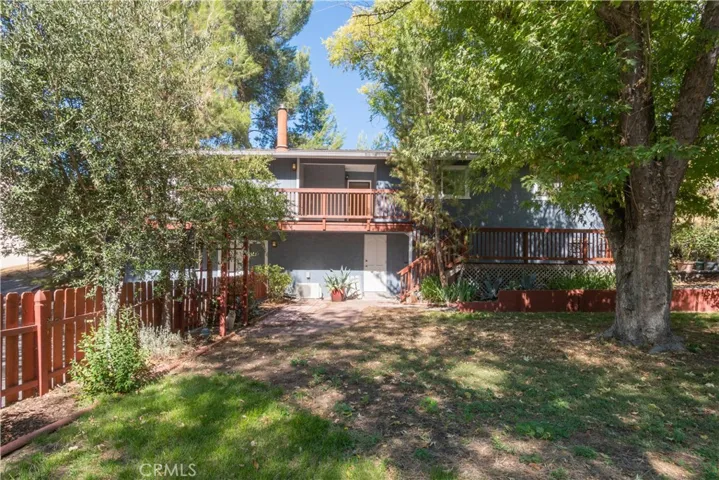 The fencing separates the driveway from the yard space and there is a full size door for access under the house.