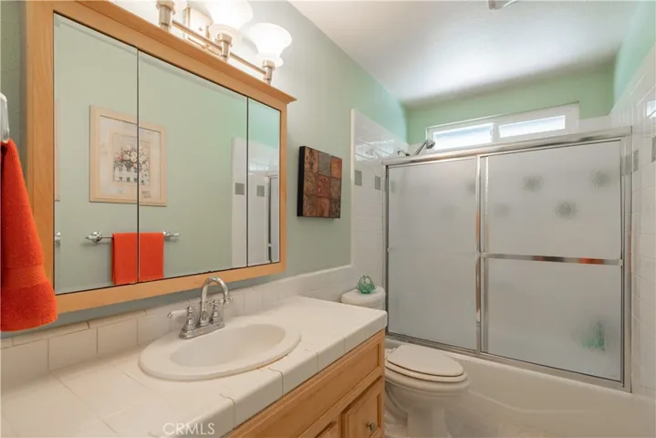 Hall bath with updated tile work at the tub area.