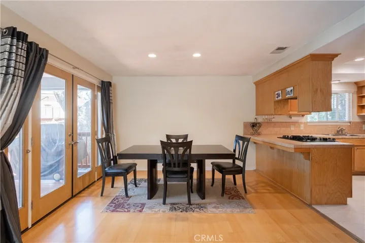 This dining area has French doors leading to a larger portion of the deck with a peak toward the West Hills of Paso