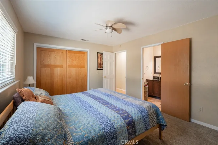 Master bedroom with natural wood closet doors.