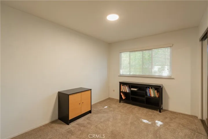 Another bedroom with mirrored closet doors.