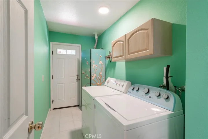 Utility room with outside access to the back of the house.  Washer and dryer will stay with the house.