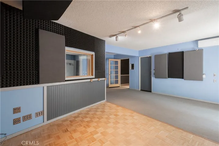 The sound studio with a view of the 2 additional rooms.  The gray door is access to the stairway up and a 1/2 bath.