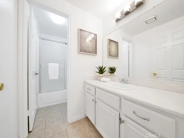 Secondary bathroom with tub shower combo and plenty of room for dual vanity