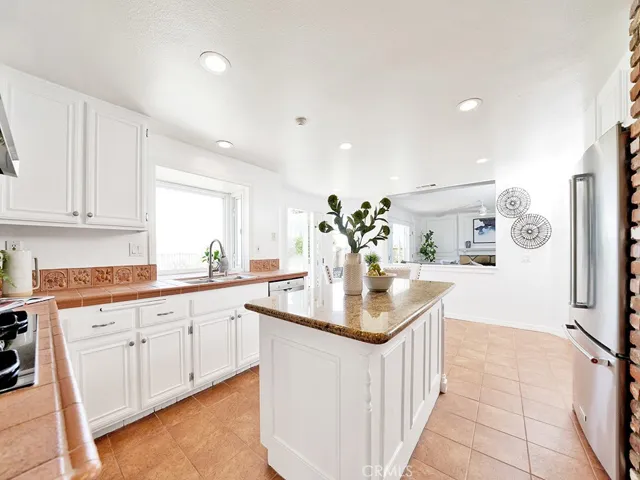 Open concept kitchen to family room can be opened up with removal of the wall in this photo!