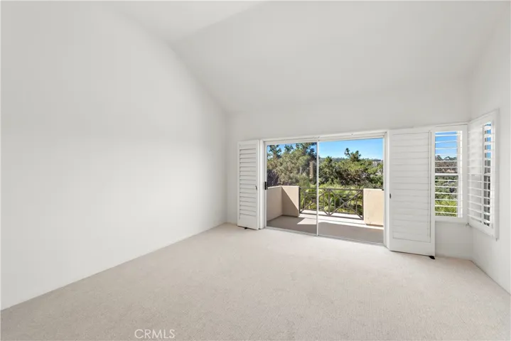 Primary suite with a balcony and fireplace