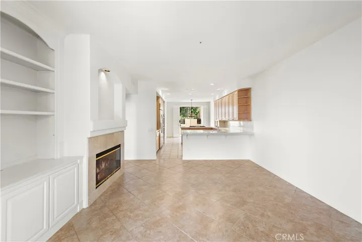 family room with built-in cabinetry and a fireplace