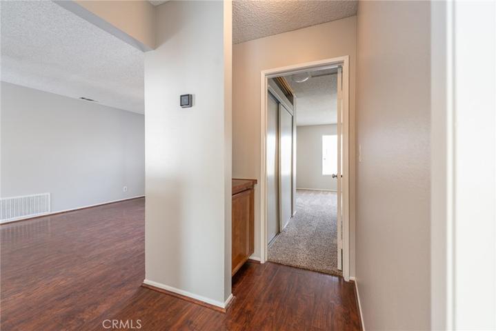 Hallway with view of living room and front bedroom entry