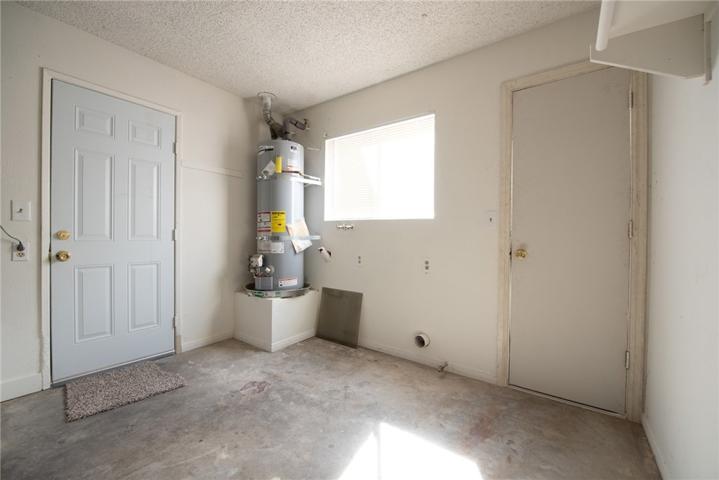 Back of garage utility room with laundry hookups.