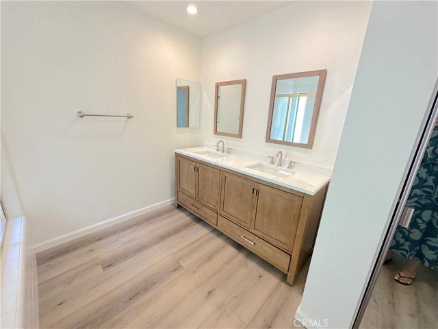 Main bath sinks and mirrored closet