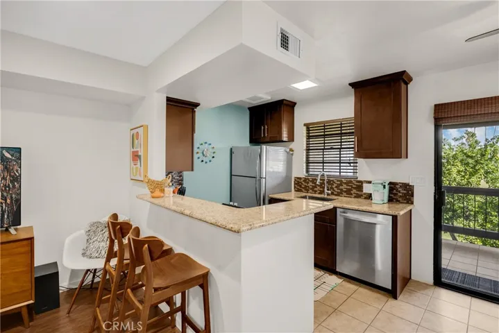 Eat Up Bar Area at Kitchen Space allows for Informal Dining Space that Flows to Living Room