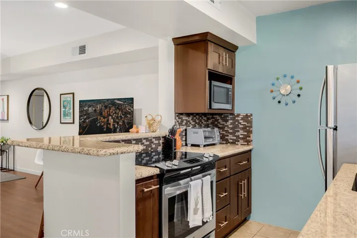 Electric Range, Soft Close Cabinets, and Spice Rack Pull-Out Top Off Granite Counters, and Beautiful Kitchen