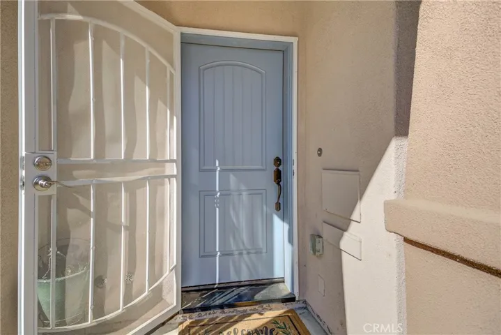 Front entry with metal screen door.