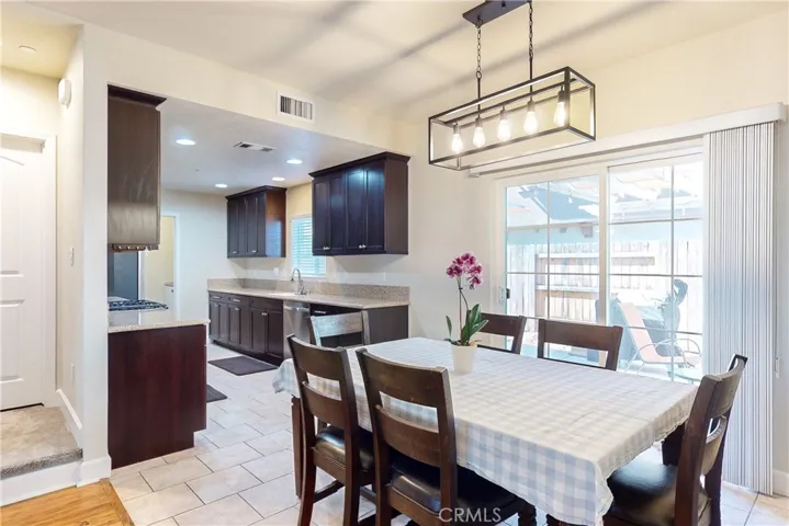 Dining area with sliding glass door that opens to outdoor patio and backyard.