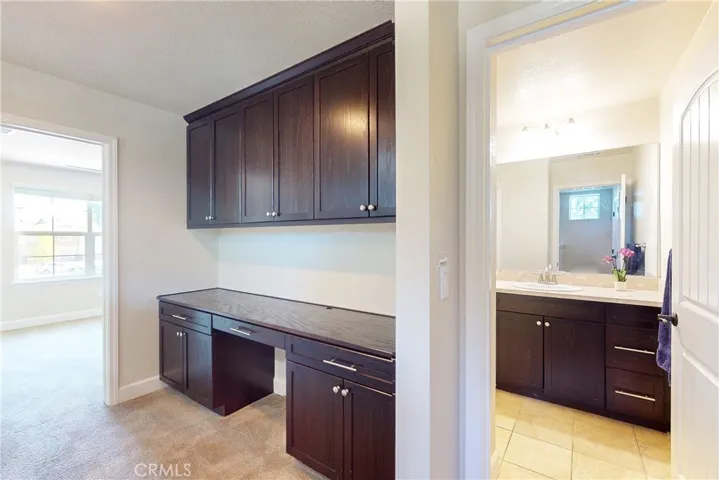 Upstairs hallway built-in cabinets and office desk.