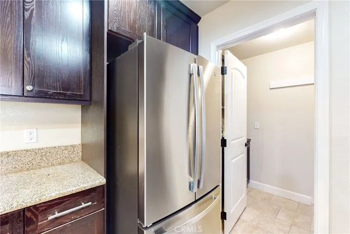 Stainless steel refrigerator and door to the laundry room.