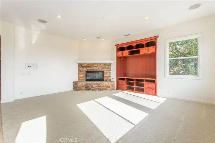 Family room with raised hearth fireplace and built-in entertainment center