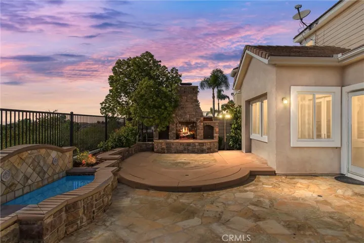 Built-in fountain and custom outdoor fireplace