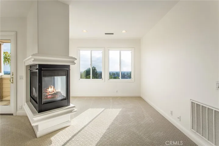 Master suite dual sided fireplace and sitting area