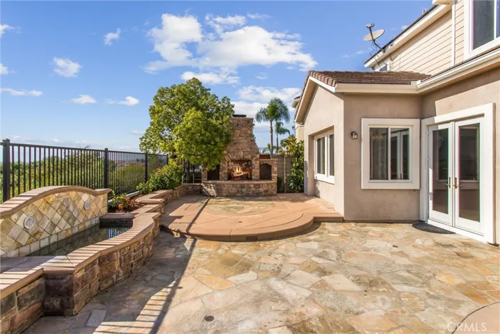 Built-in fountain and custom outdoor fireplace