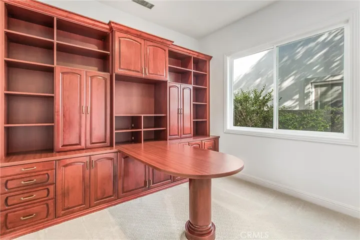 Downstairs office with walk-in closet and built- in desk