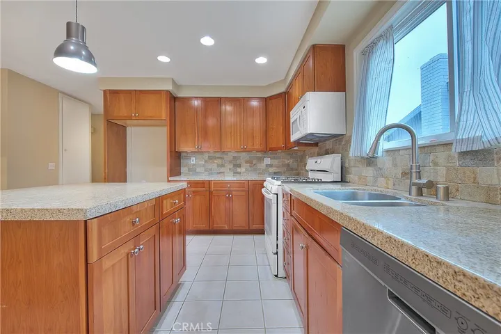 Preview 4 of 10 – Bright Kitchen with Recessed Lighting and Newer Cabinets
