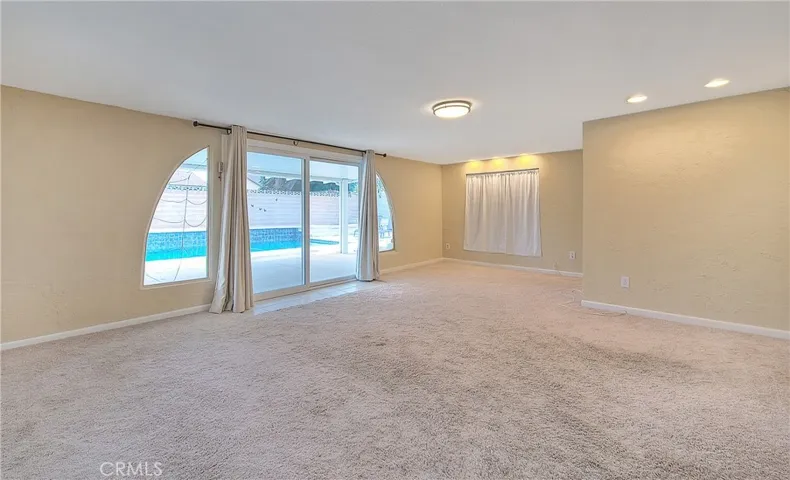 Preview 5 of 10 – Separate Family Room overlooking Covered Patio, Backyard, and Swimming Pool